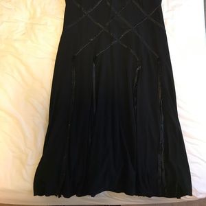 Knee length black dress with lattice pattern top
